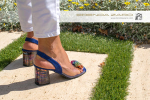 Woman with blue shoes and coral accesorie from behind